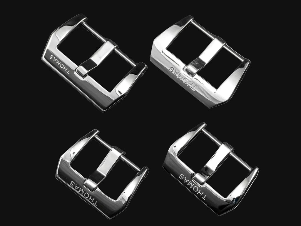 Four silver watch strap buckles with different widths on a dark background, branded 'THOMAS'.